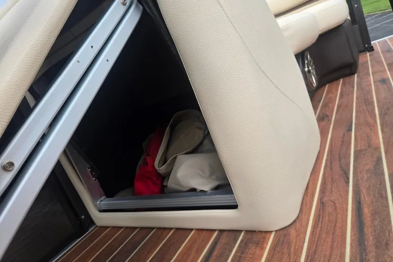 Slide: The Image of Storage compartment on 2016 Crest Classic 230 Chateau boat with wooden flooring. - 23