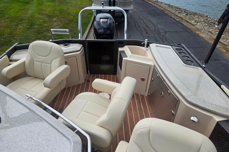 Slide: The Image of 2016 Crest Classic 230 Chateau boat interior with plush seating and sleek design. - 17