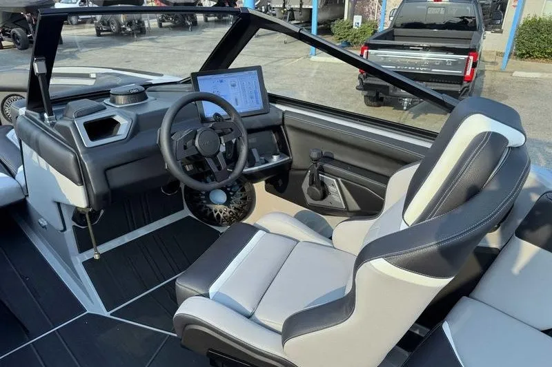 Slide: The Image of 2027 Supra R225 boat interior with modern dashboard and steering wheel design. - 2