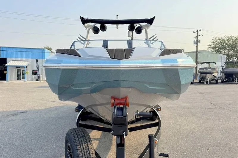 Slide: The Image of 2027 Supra R225 boat on trailer, front view in outdoor setting. - 9