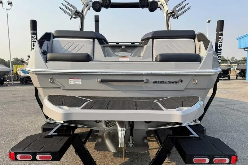 Slide: The Image of 2027 Supra R225 boat rear view with Swell Surf system on trailer. - 8
