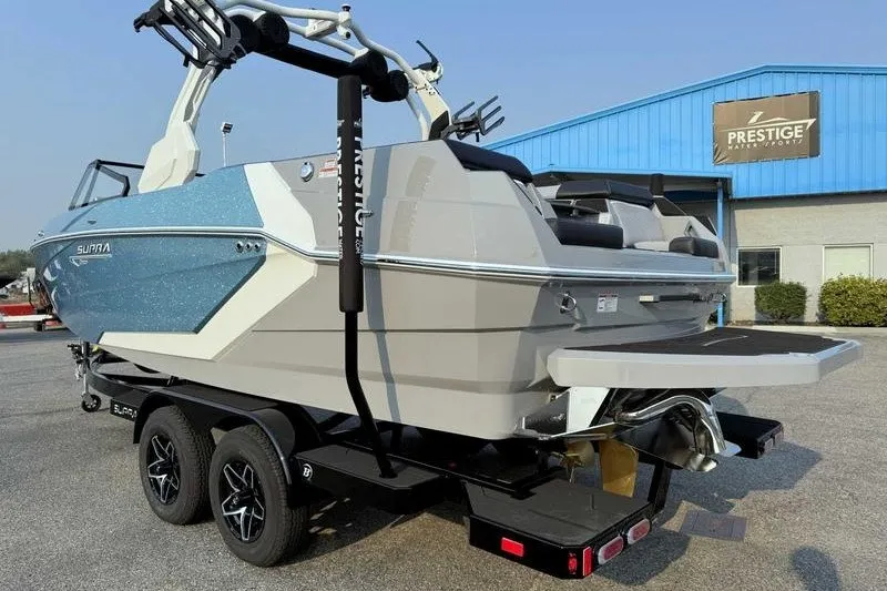 Slide: The Image of 2027 Supra R225 boat on trailer outside Prestige dealership. - 7
