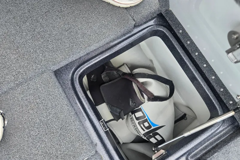 Slide: The Image of Storage compartment in a 2021 Phoenix 920 Elite boat with a life jacket inside. - 24