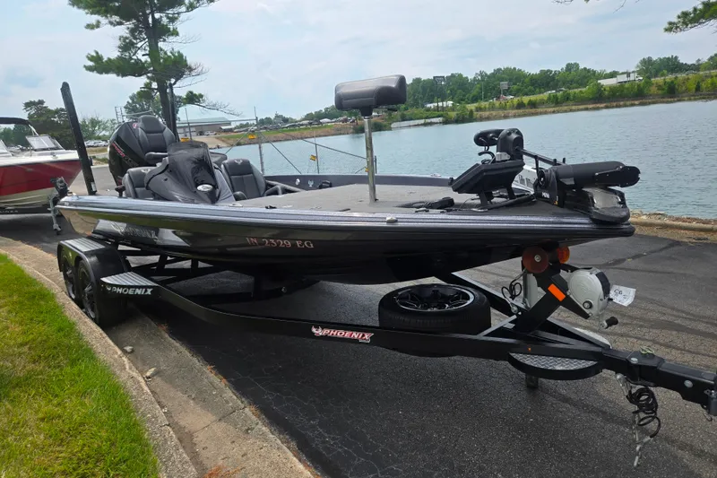 Slide: The Image of 2021 Phoenix 920 Elite boat on trailer by a lakeside road. - 9