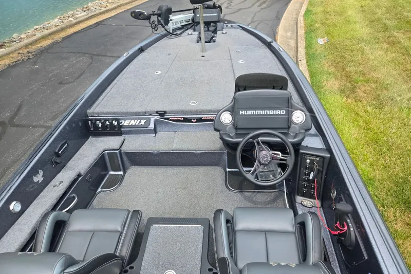 Slide: The Image of 2021 Phoenix 920 Elite boat interior with steering wheel and Humminbird electronics. - 11