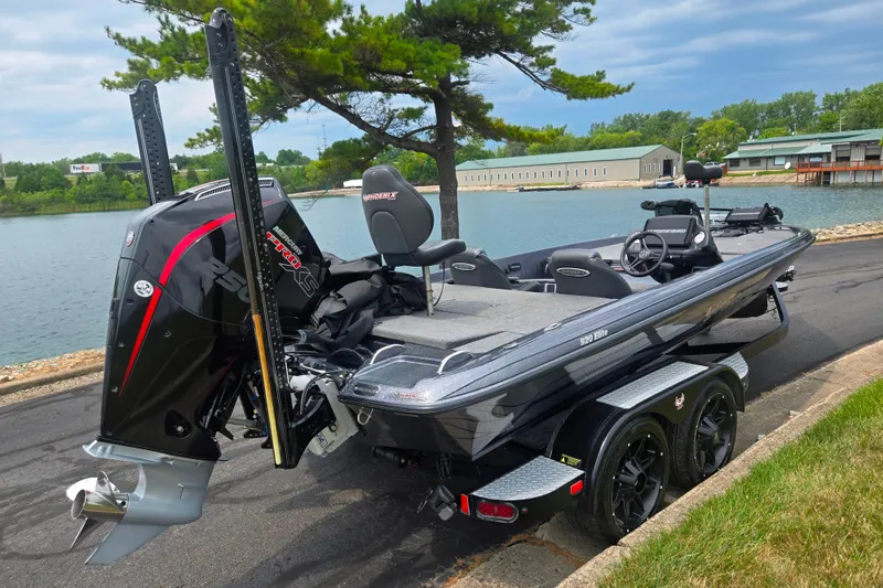 Slide: The Image of 2021 Phoenix 920 Elite boat with powerful engine, parked by a scenic lakeside. - 1