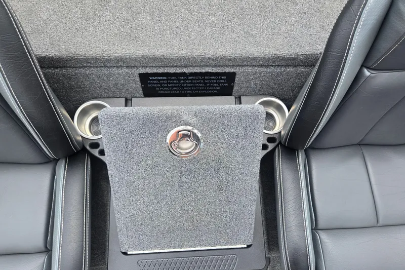 Slide: The Image of Interior of a 2021 Phoenix 920 Elite boat, featuring cup holders and a storage compartment. - 22