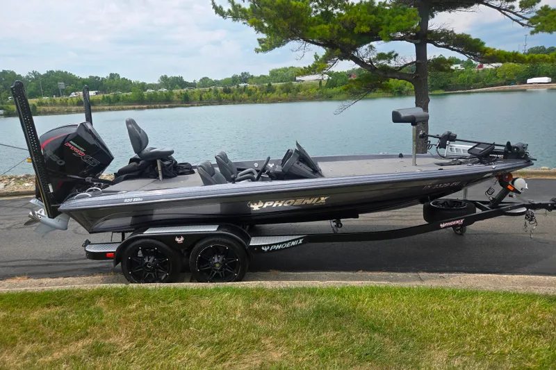 Slide: The Image of 2021 Phoenix 920 Elite boat on trailer by a lakeside road. - 10