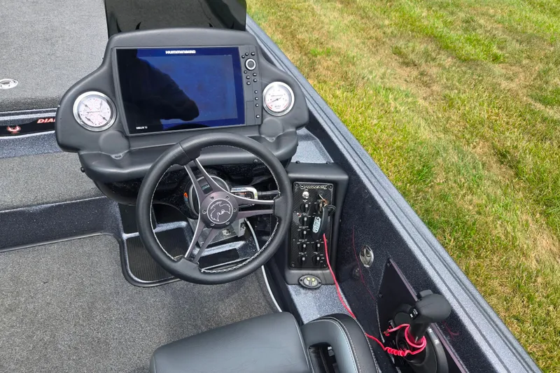 Slide: The Image of 2021 Phoenix 920 Elite boat dashboard with steering wheel and electronic display. - 13
