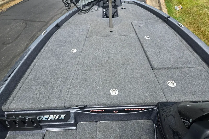Slide: The Image of 2021 Phoenix 920 Elite boat deck with gray carpeting and storage compartments. - 14
