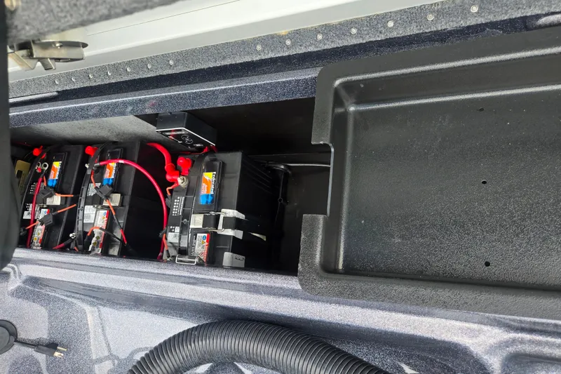 Slide: The Image of Battery compartment of 2021 Phoenix 920 Elite boat with multiple batteries and wiring. - 25