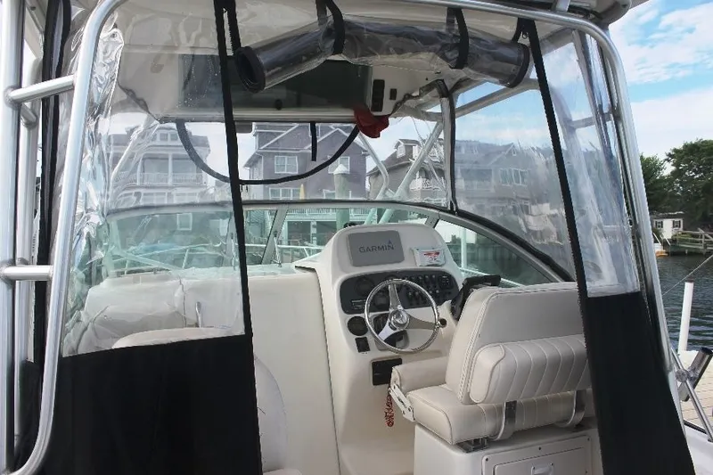 Slide: The Image of 2006 Robalo R265 Walkaround boat interior with steering wheel and Garmin navigation system. - 16