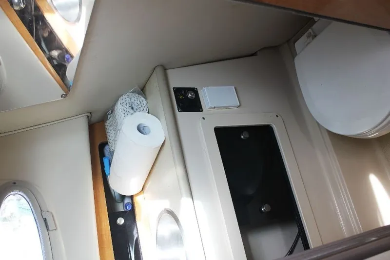Slide: The Image of 2006 Robalo R265 Walkaround cabin interior with storage and toilet. - 21