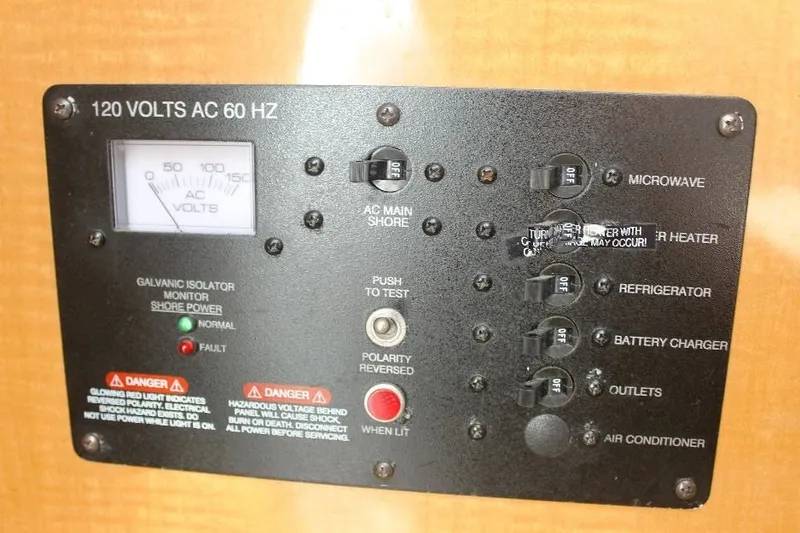 Slide: The Image of Electrical panel of a 2006 Robalo R265 Walkaround boat, showing AC voltage controls. - 13