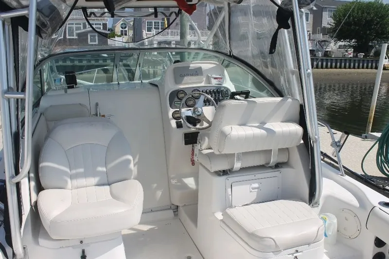 Slide: The Image of 2006 Robalo R265 Walkaround boat interior with steering wheel and seating. - 25