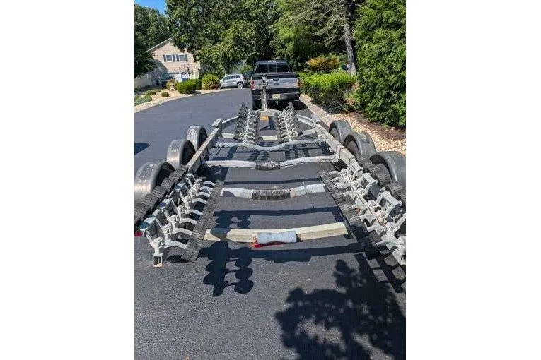 Slide: The Image of Trailer for 2006 Robalo R265 Walkaround boat parked on a residential street. - 7
