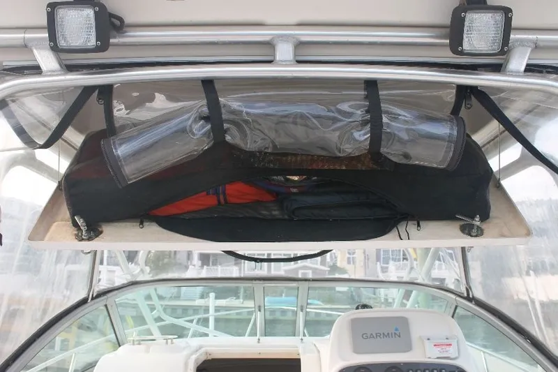 Slide: The Image of 2006 Robalo R265 Walkaround boat interior with storage compartment and Garmin equipment. - 15