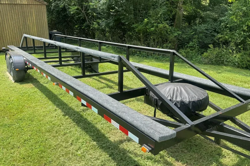 Slide: The Image of Trailer for 2011 Catamaran Cruisers Lil Hobo 31 on grassy area near trees. - 44