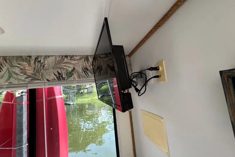 Slide: The Image of Interior of 2011 Catamaran Cruisers Lil Hobo 31 with mounted TV and lake view. - 25