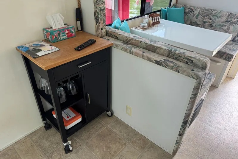Slide: The Image of Interior of 2011 Catamaran Cruisers Lil Hobo 31 with dining area and storage cart. - 20