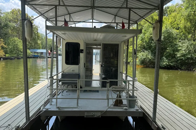 Slide: The Image of 2011 Catamaran Cruisers Lil Hobo 31 houseboat docked on a serene lake. - 11