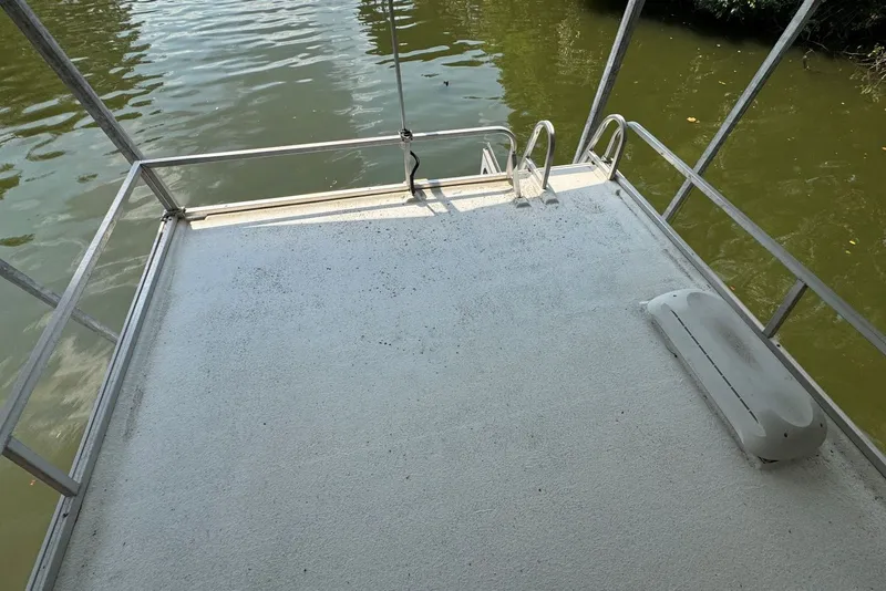 Slide: The Image of Rear deck of a 2011 Catamaran Cruisers Lil Hobo 31, overlooking calm water. - 42