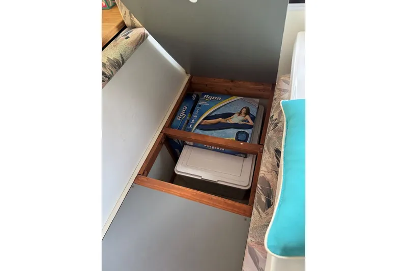 Slide: The Image of Under-seat storage in 2011 Catamaran Cruisers Lil Hobo 31 with inflatable pool float and cooler. - 22