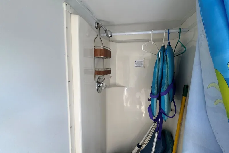 Slide: The Image of Interior of 2011 Catamaran Cruisers Lil Hobo 31 with life jackets and shower area. - 33