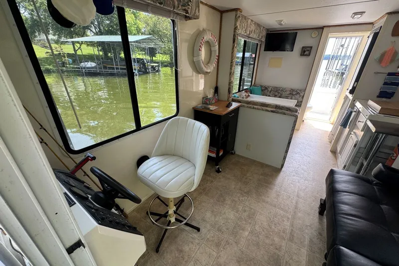 Slide: The Image of Interior of 2011 Catamaran Cruisers Lil Hobo 31 houseboat with helm, seating, and lake view. - 13