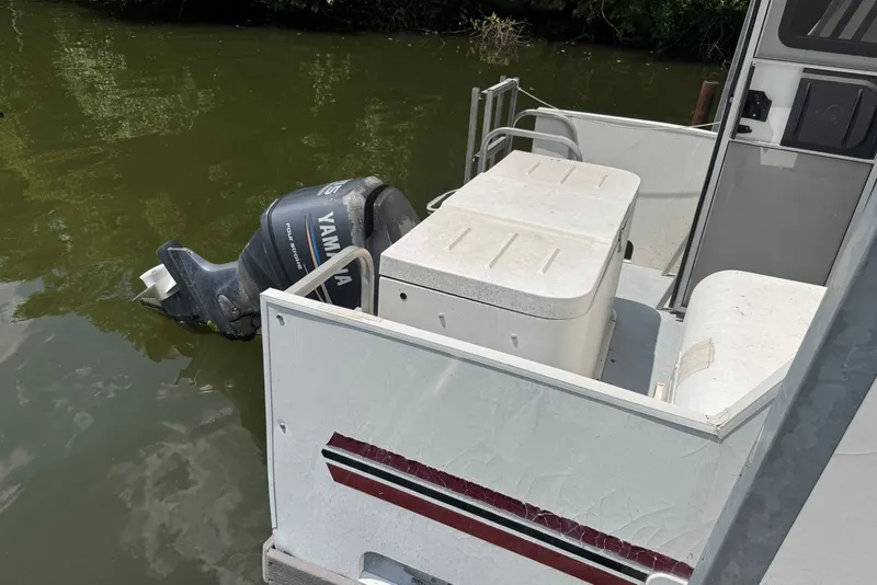 Slide: The Image of 2011 Catamaran Cruisers Lil Hobo 31 with Yamaha outboard motor on calm water. - 9
