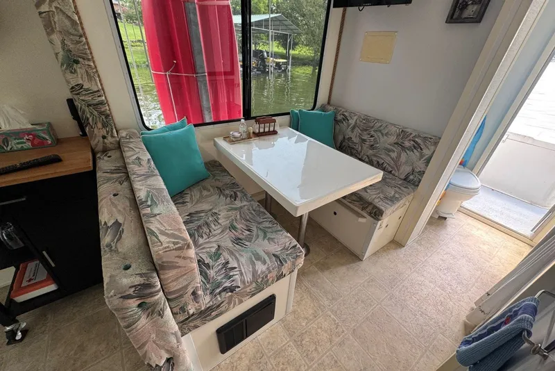 Slide: The Image of Interior of 2011 Catamaran Cruisers Lil Hobo 31 with cozy dining area and lake view. - 21