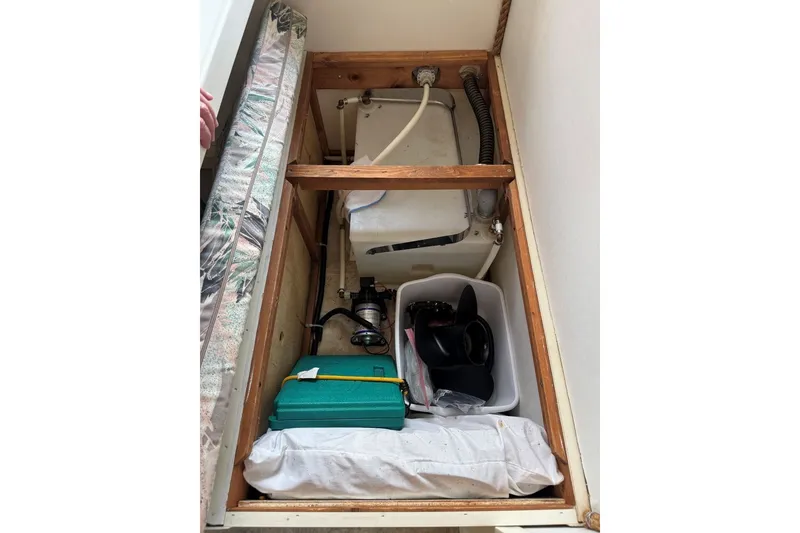 Slide: The Image of Storage compartment in a 2011 Catamaran Cruisers Lil Hobo 31, featuring equipment and supplies. - 23