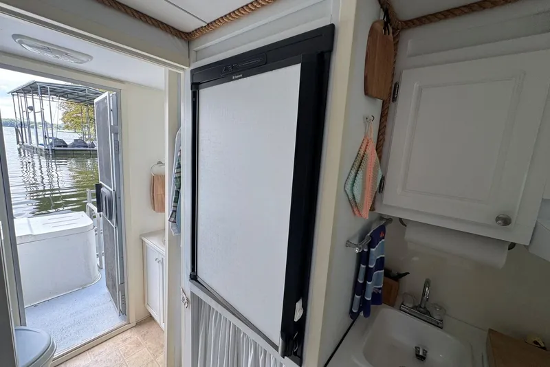Slide: The Image of Interior of 2011 Catamaran Cruisers Lil Hobo 31 with kitchenette and lake view. - 29