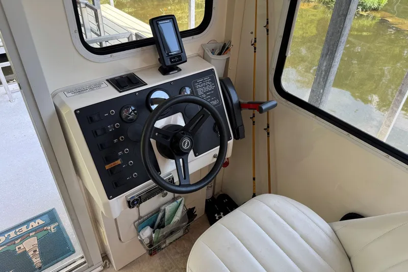 Slide: The Image of Steering console of 2011 Catamaran Cruisers Lil Hobo 31 with navigation equipment. - 16
