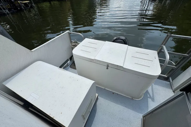 Slide: The Image of 2011 Catamaran Cruisers Lil Hobo 31 boat deck with storage compartments by the water. - 34