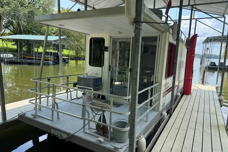 Slide: The Image of 2011 Catamaran Cruisers Lil Hobo 31 houseboat docked on a serene lake. - 3
