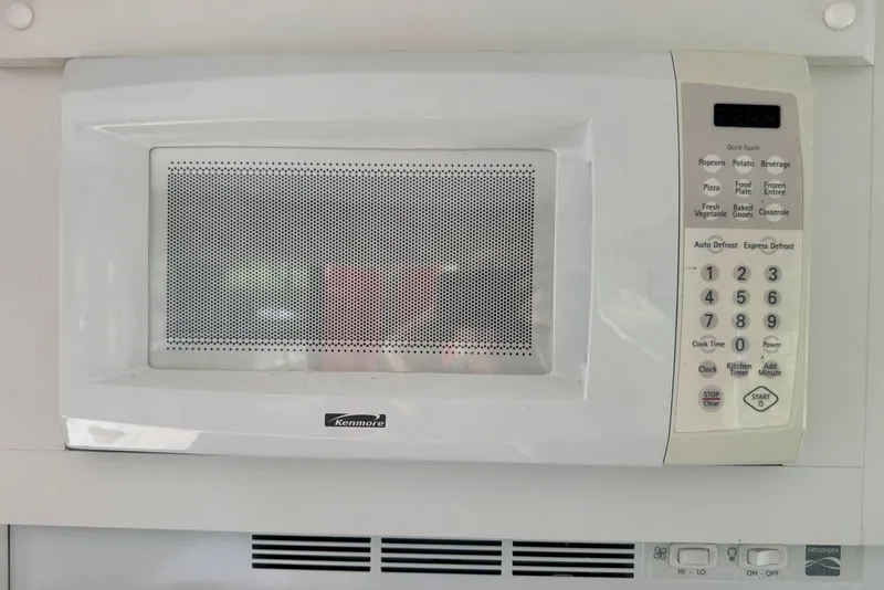 Slide: The Image of Built-in Kenmore microwave in a 2011 Catamaran Cruisers Lil Hobo 31 houseboat kitchen. - 28