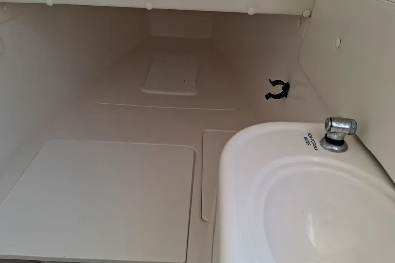 Slide: The Image of Interior of 2020 Century 3200 Center Console boat with sink and storage area. - 15