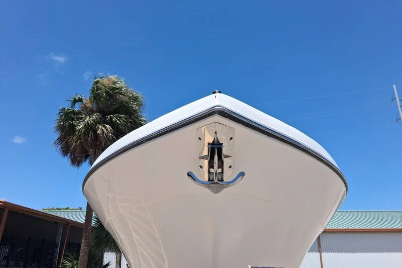 Slide: The Image of Century 3200 Center Console boat, 2020 model, viewed from the front against a clear blue sky. - 1