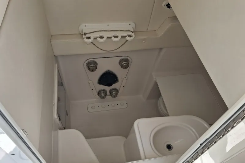 Slide: The Image of Interior of a 2020 Century 3200 Center Console boat, featuring a compact sink and storage area. - 16