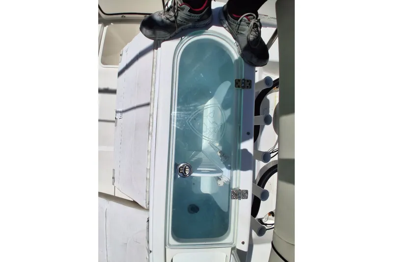 Slide: The Image of 2020 Century 3200 Center Console boat deck with livewell and rod holders. - 17