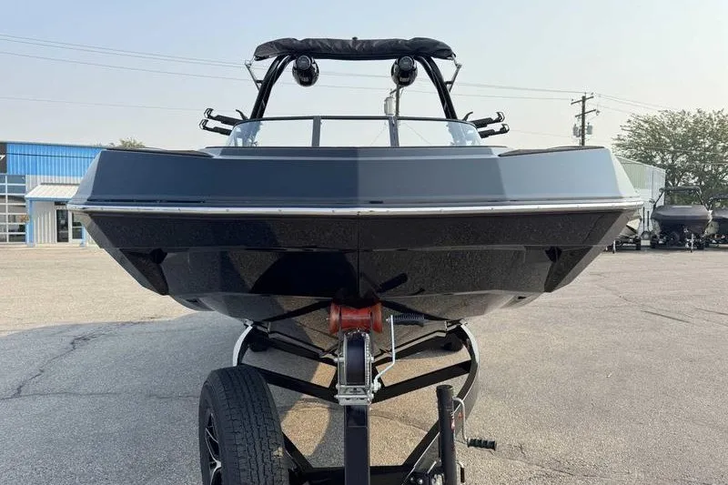 Slide: The Image of 2027 Moomba Tykon boat on trailer, front view in outdoor setting. - 3