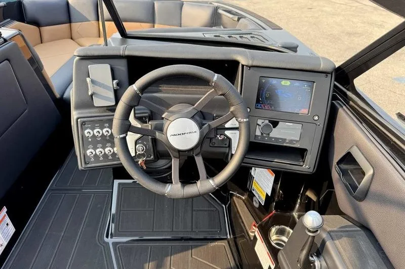 Slide: The Image of 2027 Moomba Tykon boat dashboard with steering wheel and control panel. - 8