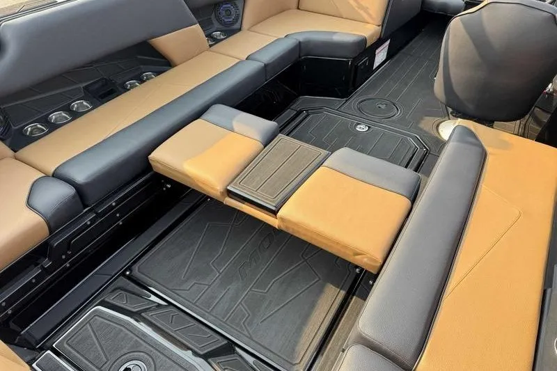 Slide: The Image of Interior of 2027 Moomba Tykon boat with tan and black seating. - 11