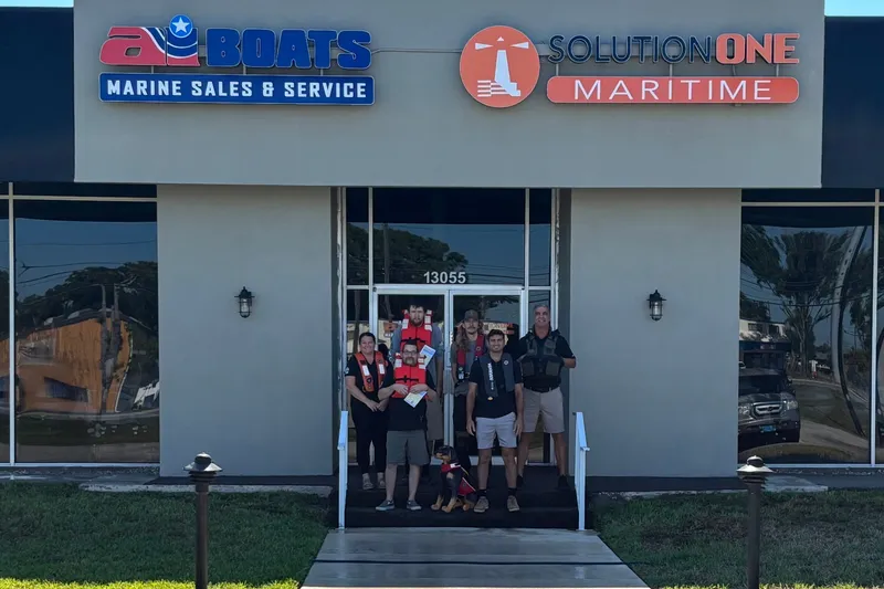Slide: The Image of Group outside AI Boats Marine Sales & Service, Solution One Maritime building, 2026 Caribe ub13sc. - 5