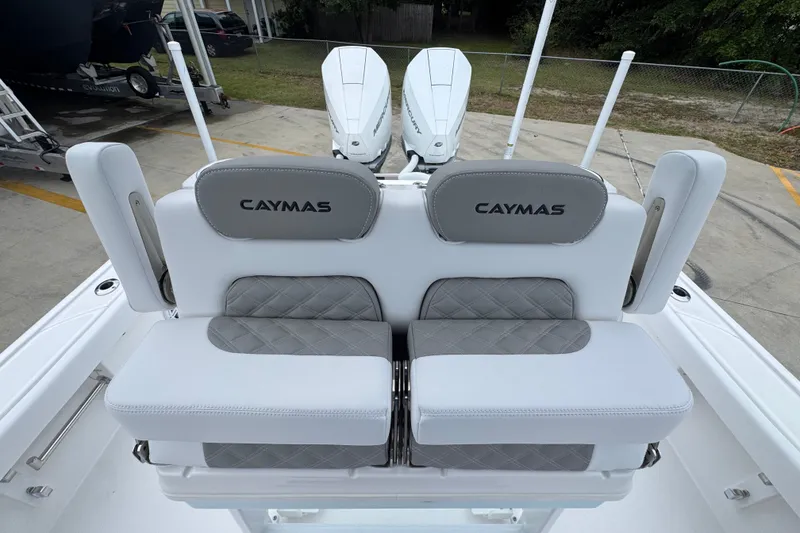 Slide: The Image of 2027 Caymas 281 HB boat seating with dual engines, featuring gray and white upholstery. - 32