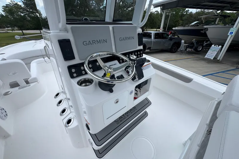 Slide: The Image of 2027 Caymas 281 HB boat helm with Garmin electronics and Mercury steering wheel. - 35