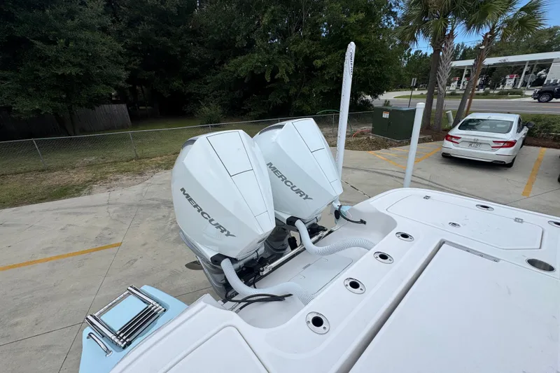 Slide: The Image of 2027 Caymas 281 HB boat with dual Mercury outboard engines in a parking area. - 50