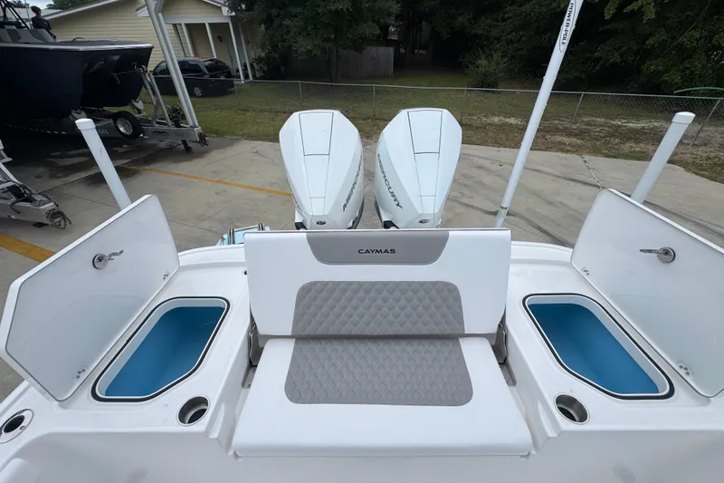 Slide: The Image of 2027 Caymas 281 HB boat with dual Mercury engines and open storage compartments. - 47