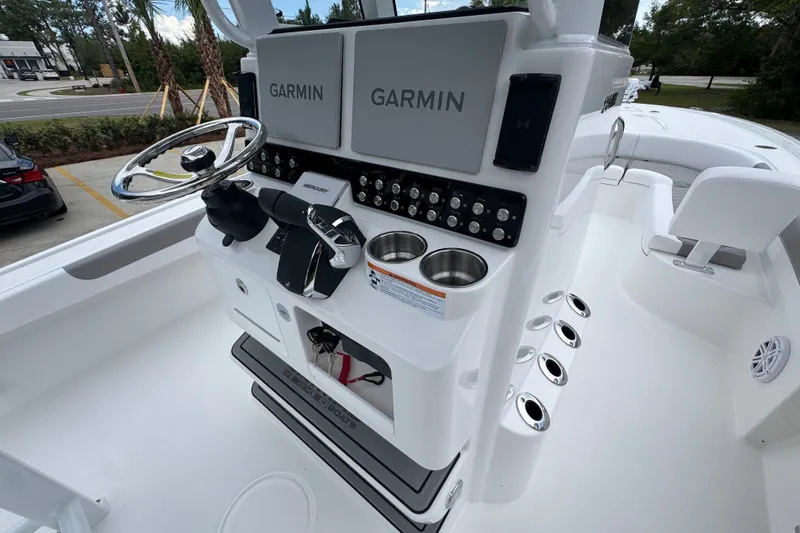 Slide: The Image of 2027 Caymas 281 HB boat console with Garmin displays and steering wheel. - 39